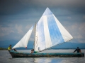 A local family sail a traditional boat around the San Blas Islands, Panama.