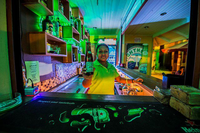 A woman selling beer at a local bar in San Ignacio