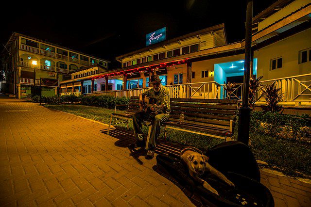 A man sitting on a bench in San Ignacio playing music