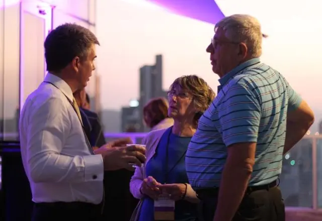 A conference expert speaking with attendees