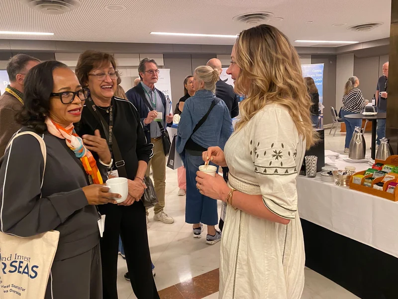 Conference attendees chatting and networking with experts during breaks