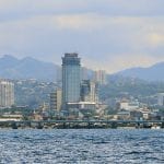 buildings and mountains as seen from the ocean in Cebu City