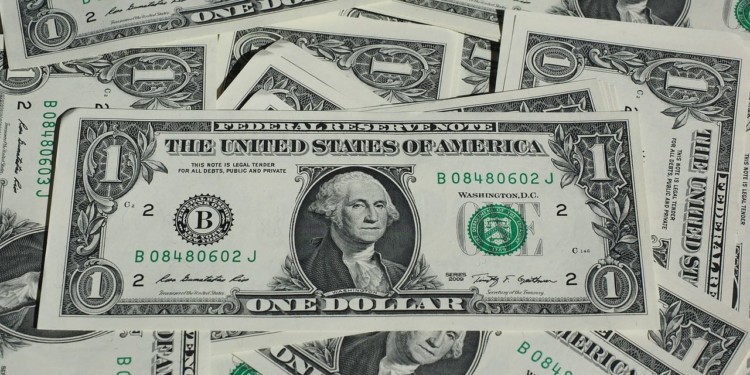 a messy pile of dollar bills