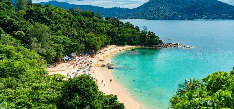 aerial view of people enjoying an isolated beach in phuket thailand