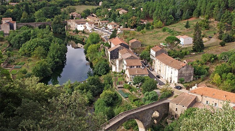 Stone houses line the river in the Languedoc