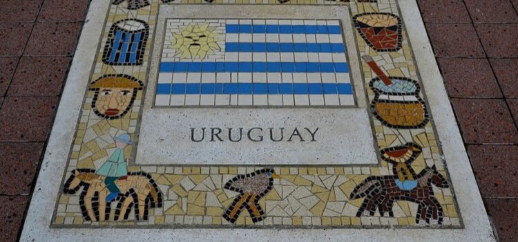 A plaque of pastimes from Uruguay, including the local people, birds, drums, and the country's flag.