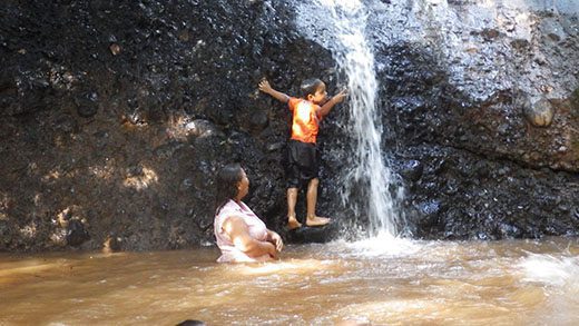 Two kids playing in a river
