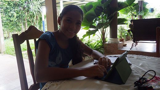 A girl playing on her new tablet