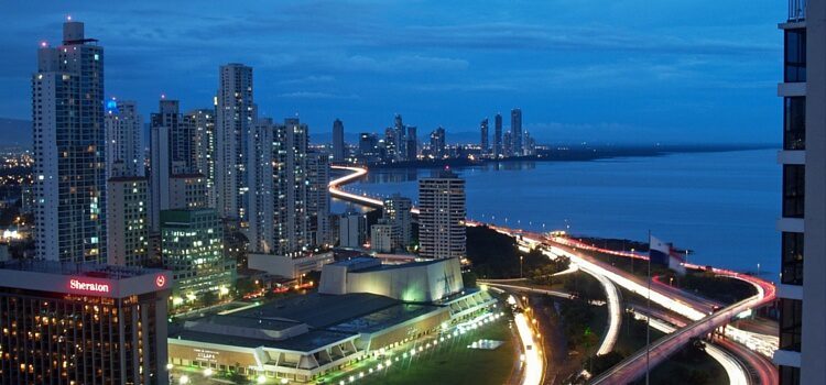 Panama City at dusk, with busy streets, buildings with a few lights on, and a city fast on the move.