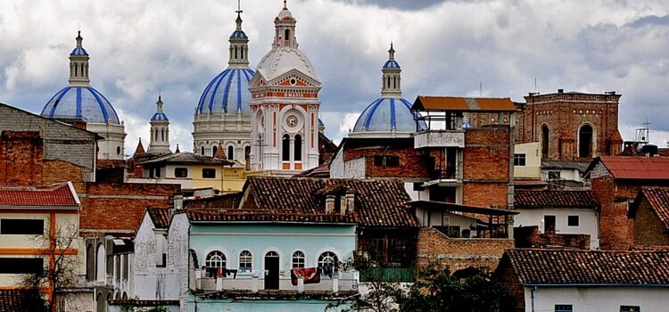 The beautiful brick buildings, softly painted buildings, and jutting church steeples of Cuenca Ecuador