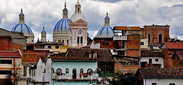 The beautiful brick buildings, softly painted buildings, and jutting church steeples of Cuenca, Ecuador