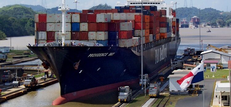 Large container ship going through the Panama Canal with lots of cargo containers