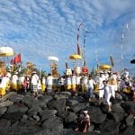 People celebrating a buddhist ceremony on a rock hill in Indonesia