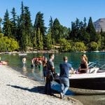 People enjoying a beach in Queenstown, New Zealand