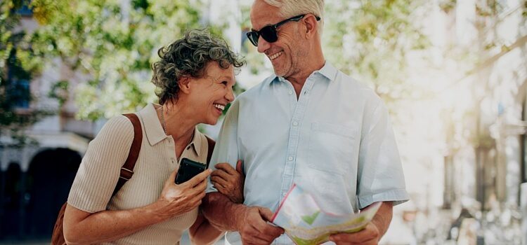 A couple retired in Panama laughing and looking at a map while planning their next adventure