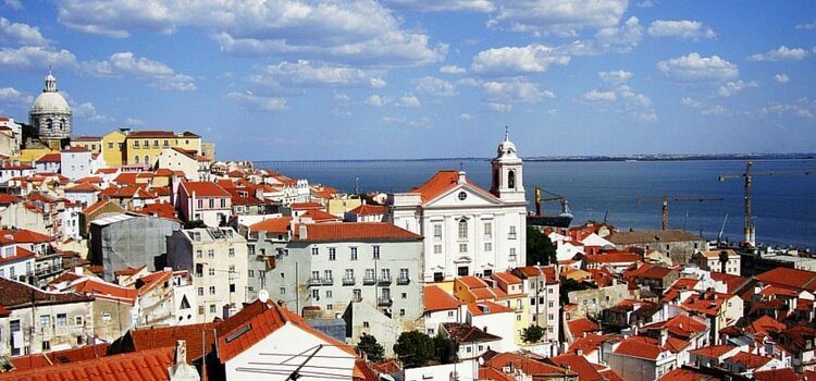 A view of the orange roofed, white buildings throughout Lisbon, Portugal