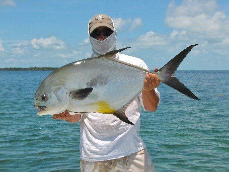 A man holding a Permit fish
