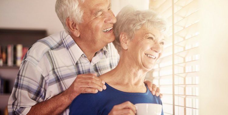 A retired couple looking out the window contemplating retirement abroad.