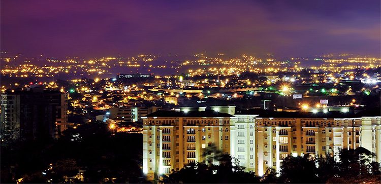 San Jose buildings lit up at night, infrastructure in costa rica