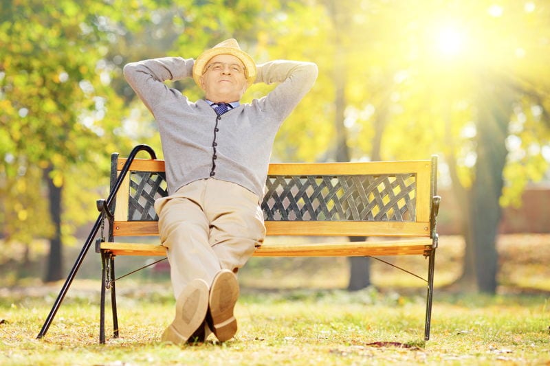 Retired man sitting on a bench