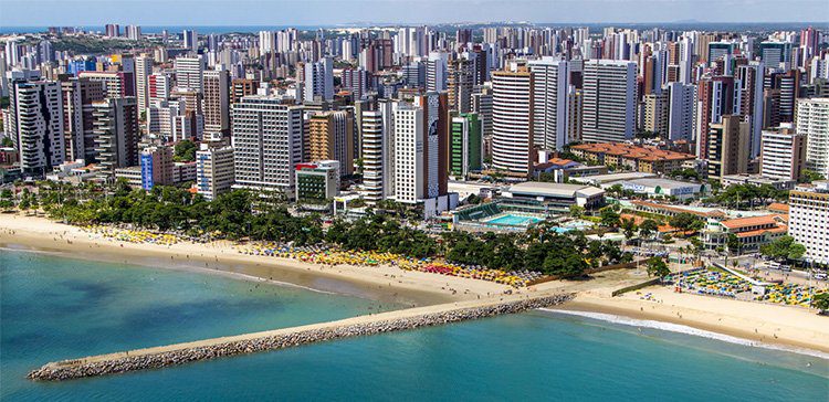 apartment and office buildings as far as the eye can see along the coastline of fortaleza brazil