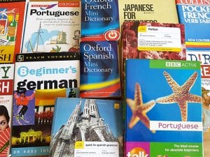 assorted language books laid out on a table