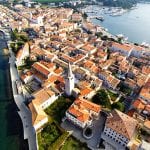 aerial view of red roofed buildings on the coast in croatia