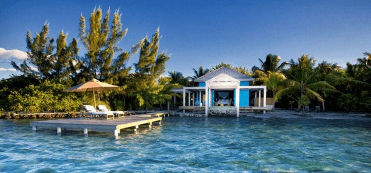 a wooden house with a dock on an island in Belize