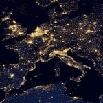 A map of Europe at night, with all the major regions lit up with lights.