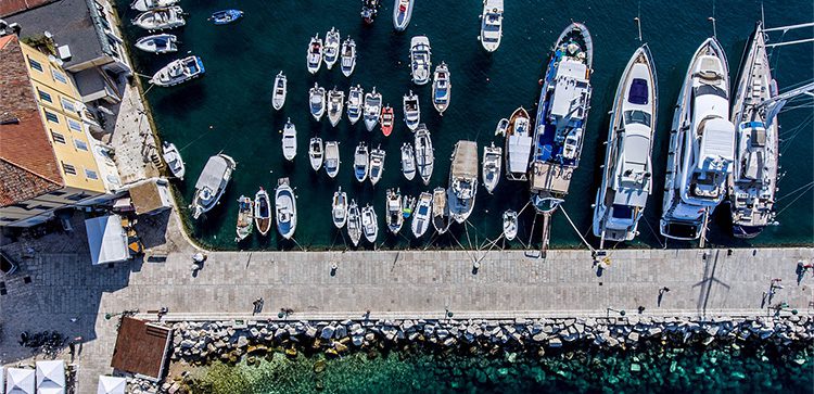 a marina with large and small boats as seen from above. invest in croatia