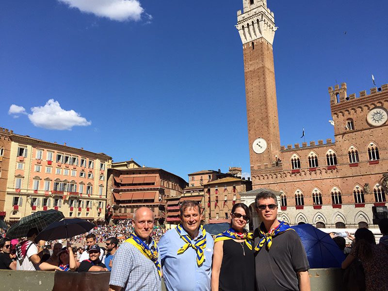 Kathleen and Lief standing with two friends among the crows at the Palio