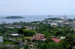 small coastal town with lush trees and small houses