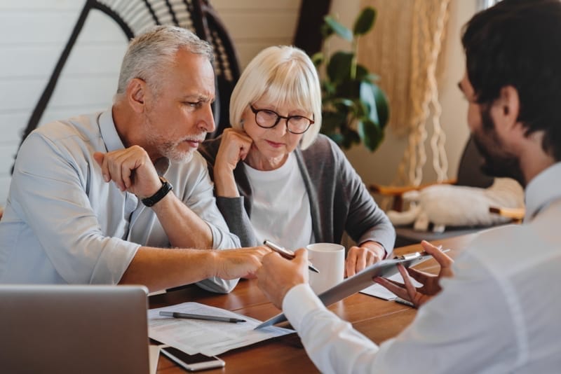 Attorney explaining paperwork to a senior couple.