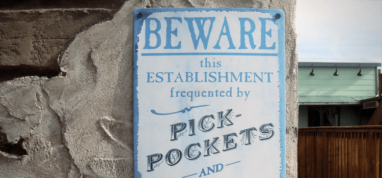 A Sign saying "Beware this establishment is frequented by pickpockets."