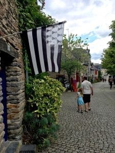 A Black and White Brittany flag hangs on a stone building