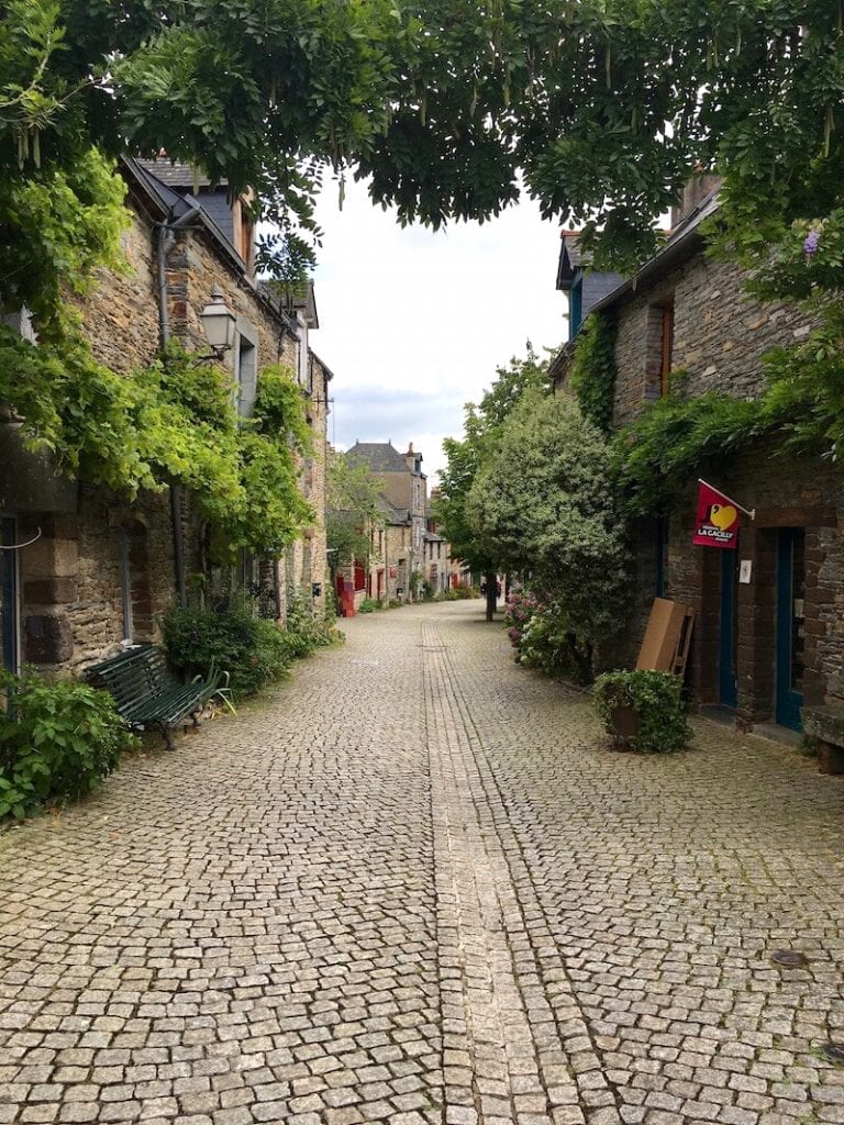 An empty cobblestone street lined by stone buildings
