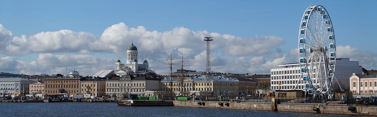a harbor in helsinki with a ferris wheel
