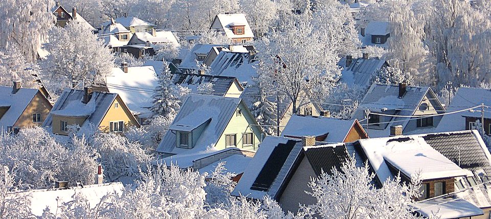 snow covered trees and rooftops in estonia