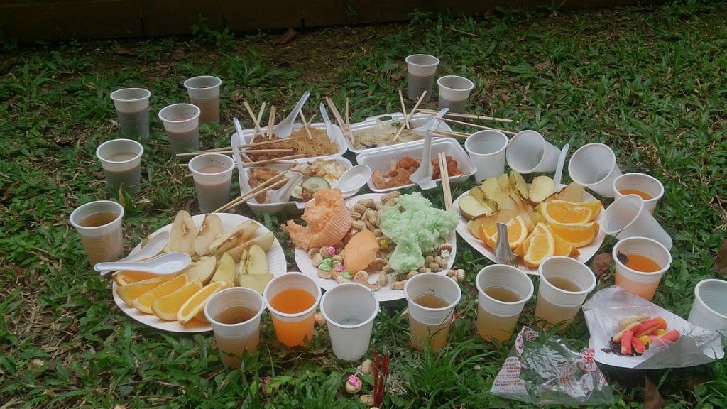 Food and drinks laid out on the group as an offering for hungry ghosts
