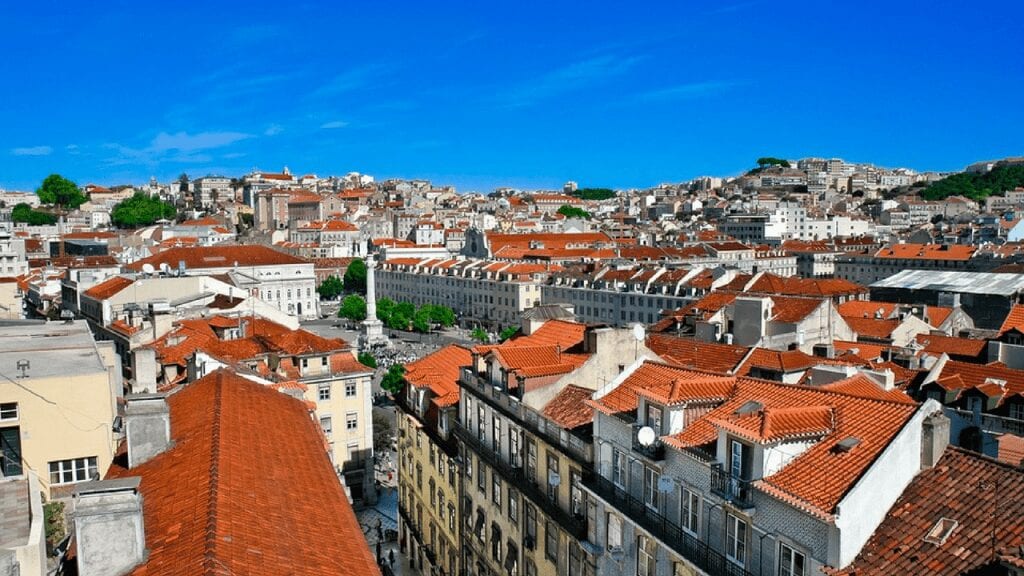 low rise lisbon neighborhood where you can see the blue sky above red tile roofs