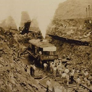 historic train and men working on the original digging of the panama canal