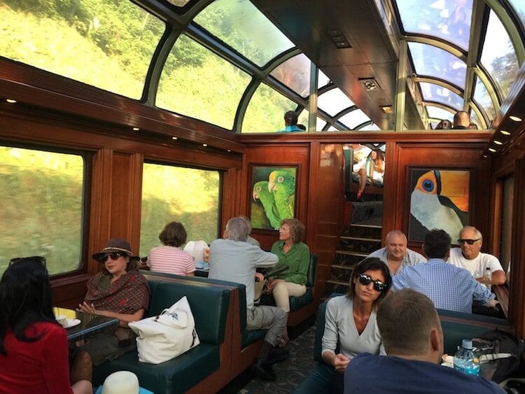 view of the one of the carriages in the panama canal train. old style carriage with wood panels and glass ceiling