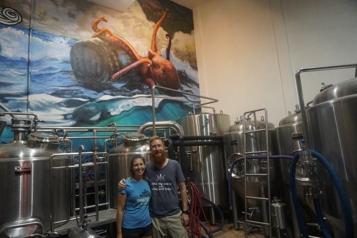 Owners of Monzon Brewing in front of a brewing vat