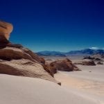 A sandy desert in Chile with a deep blue sky