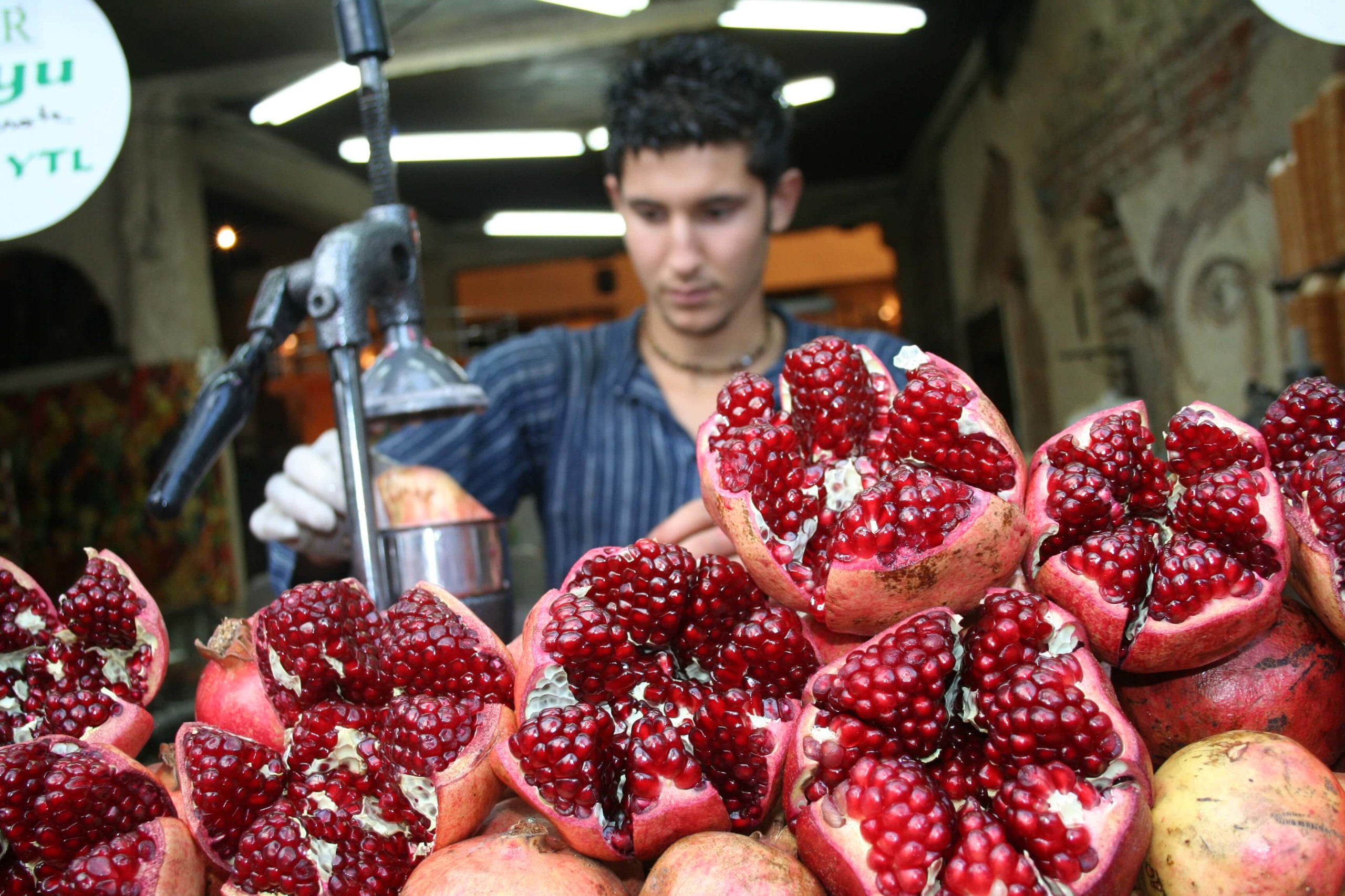 A boy makes pomegranate juice at a Turkish market