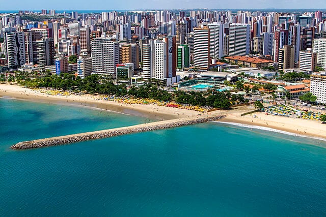 A view of the Fortazela skyline with the bright blue ocean in the front. One of the cheapest countries to buy real estate