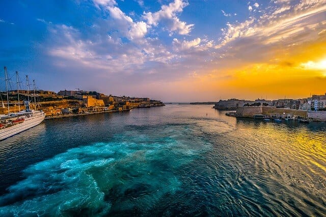 Sun shines over the historic harbor of Valletta, Malta.