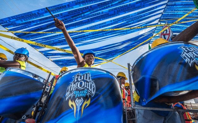 A drummer playing at a street parade in Belize