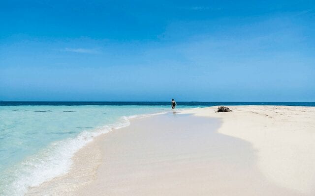 A lady on a tropical beach in Belize