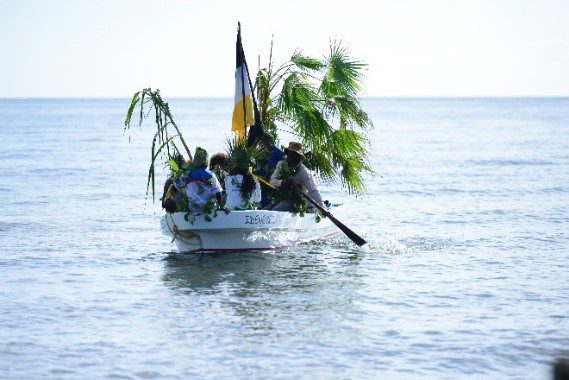 Garifuna reenactment boats approach the shore